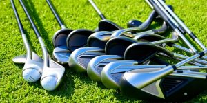 Various golf clubs on green grass, ideal for beginners.
