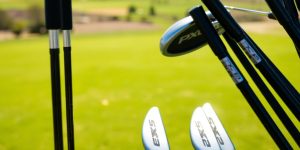 Full set of shiny PXG golf clubs.